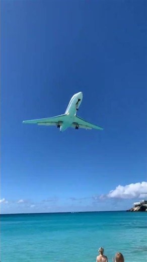 Small plane flying over Maho Beach