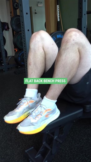 A slight or extreme arch isn’t just a “powerlifter thing.” By retracting your shoulder blades, bracing your core, and creating a small lumbar curve, you can shorten the bar path, recruit your chest and lats more efficiently, and push heavier safely. It may seem sketchy but it’s called biomechanics. When done correctly, it reduces shoulder stress and leverages your legs to stabilize the lift. On the flip side, a flat-back bench puts you in a neutral spine position and is perfect if you’re managin