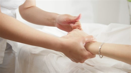 Woman massaging a girl's hand and fingers - Free Stock Video