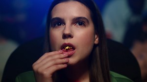 Free stock video - Focused woman watching film in cinema