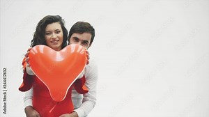 Gentle couple The beauty of the girl and her handsome guy, holding the heart in the form of balloons and kisses. Happy family is joyful. Valentine's Day