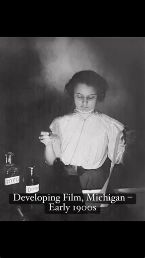 From my glass negative collection, this early 1900s photo shows a young woman in Michigan carefully developing film in a darkroom. Bottles labeled “Hypo” and “Developer” sit nearby as she studies the strip of negatives. Women photographers were rare in this era, yet here she is, confidently practicing the technical side of photography.#Restore #adobePhotoshop #PhotographyHistory #VintagePhotography #WomenInHistory | Memory Lane Photos