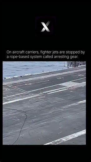 Explore X | The World And Cosmology on Instagram: "On aircraft carriers, fighter jets are stopped by a rope-based system called arresting gear. When a jet like the Harrier or modern carrier fighters lands on the moving ship, it approaches at high speed and lowers a strong tail hook. As the aircraft touches the deck, this hook catches one of several thick steel arrestor cables stretched across the runway. The cable is connected to powerful hydraulic systems below the deck, which absorb the jet’s 