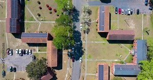 Solar photovoltaic panels installed on top of residential condo buildings for producing clean ecological electric energy. Renewable electricity with zero emission concept