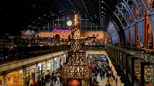 All aboard! Giant, story-telling Christmas tree arrives in London train station.