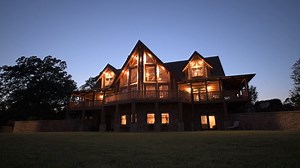 We only need one word to describe this property – Breathtaking! This immaculate 3,800 sqft., two story log home was built in 2008. It features massive logs and timber framing as well as hardwood flooring throughout. The main level is made up of the kitchen, dining, living room, and master suite. The well-equipped kitchen is complete with custom cabinets, granite countertops, tile backsplash, large bar top island, and stainless appliances. The living room and dining room surround a large stone co