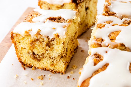 Fluffy cinnamon bun cake swirled with cinnamon sugar and topped with creamy glaze.