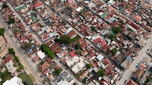 Aerial reveal shot of Banjul City landscape with mosque, roads, poor housing and harbour, Gambia, West Africa, 4K drone