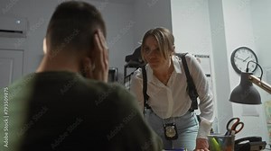 Interrogation scene with woman detective and man suspect in office, suggesting investigation.