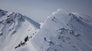 clip-1029370112-climbers-walking-mountain-expedition-aerial-flight-epic