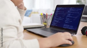 Back rear view of young asian kids boy using computer laptop coding python language programming for big data computer science lesson or tech club in online school remotely learn online school.