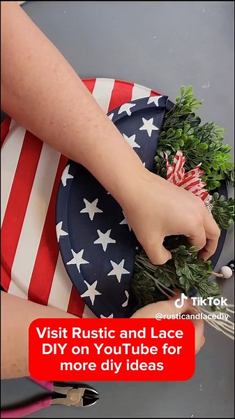 Check out this beautiful patriotic door hanger. Visit Rustic and Lace DIY on YouTube for the full slower video and to get more diy ideas. #dollartreediy #diyhomedecor #diy #crafts #homedecor #homedecordiy #patriotic #patriotic #4thofjuly #4thofjulydecor #4thofjulydiy #americana #americanadecor #memorialday #memorialdaydecor #usflag #usaflag