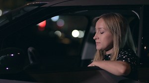 Woman answering a call in her car at night - Free Stock Video