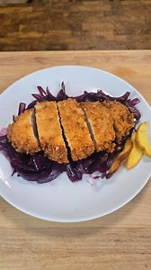 Giant Frog Katsu from Delicious in Dungeon Ingredients: ​For the Chicken: - ​2 chicken breasts - ​salt and pepper - ​120 ml water - ​60 g all-purpose flour - ​1/4 teaspoon salt - ​360 ml Panko breadcrumbs - ​Oil for frying (5 cm depth) ​For the Onions: - ​30 ml olive oil - ​1 large red onion - ​120 ml red wine - ​120 ml chicken stock - ​1 tbsp soy sauce Instructions: ​Cook onions in olive oil until soft (about 8 mins). Add red wine and cook for 5 minutes. Stir in chicken stock and soy sauce and 