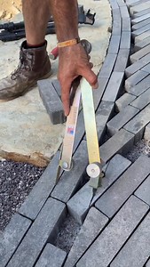 Hussle n flow… 🎨⚒️ Out here w/ @johnhenrycompanies and this thingamajiggy dialing in a smooth border cut. Overlaying the pattern and score cutting ensures a continuous flowing line from paver to paver along this triple border. After the score cut we chop off the excess and lay them back into place with the inside border pavers. #distinctive #outdoorliving #designbuild #sickbrick | Preston Hardscape Design