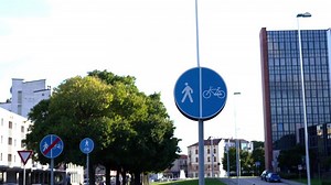 Road sign of people and bicycle lane located on city street