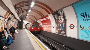 LONDON, ENGLAND - January 21, 2023: People walking in Covent Garden Underground tube statin in London at the festive season to celebrate christmas and new year