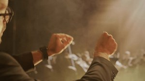 Orchestra Conductor Leading Symphony Hands Dramatic Lighting Musical Performance Music Expression