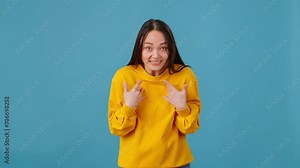 Female pointing at herself and asking me in colorful studio