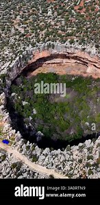 Rich vegetation flourishing inside massive sinkholes, cennet and cehennem, located near silifke, mersin, representing dramatic karst landscape formation within mediterranean taurus mountain terrain Stock Video Footage - Alamy