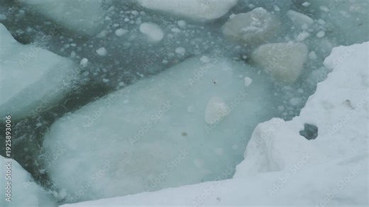 Ice floes and slush on cold river water. Winter season concept for natural phenomenon. Severe weather conditions and frozen landscape.