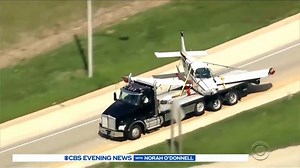 2.4K views · 30 reactions | A single-engine plane made an emergency landing on an Illinois interstate when mechanical problems prevented the pilot from making it to an airport. The plane hit the median and caused a big traffic jam. Three people on board were injured, but are expected to recover. https://cbsn.ws/3uNpcwP | CBS Evening News | Facebook