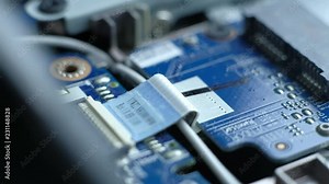 Computer Service. The serviceman cleans the interior of the laptop with dust and other dirt. 4k. Macro footage.