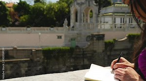 Asian Woman Standing on Bridge, Writing in her Book, Vienna - Slow Motion