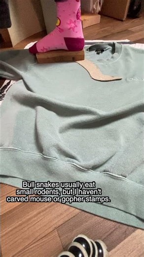 Covering up a logo on this upcycled sweatshirt with a frog patch