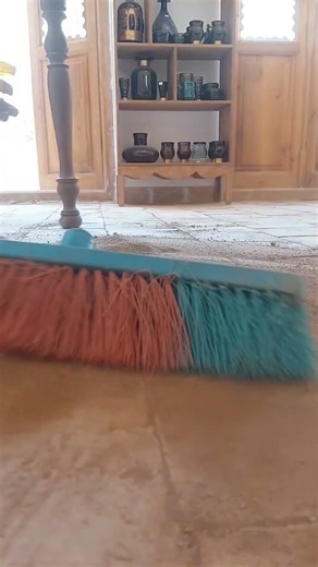 Filling the bricks joints with sifted clay soil