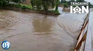 A motorist drives through the Grants Pen gully off Constant Spring Road in St Andrew on Monday, as heavy rainfall associated with #HurricaneIan impacts Jamaica. - Ricardo Makyn video. #TrackingIan #GLNRToday | Jamaica Gleaner