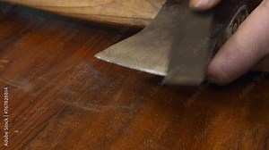 Tool closeup: Man sharpens old axe edge with whetstone on countertop Stock Video
