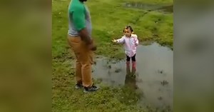 Adorable toddler entices dad to jump in mud puddle