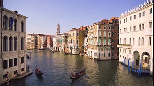 A lot of traffic and some typical Gondolas on the famous Canale Grande, the main canal in Venice, seen from the iconic Rialto Bridge.