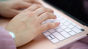 Typing on a pink laptop - Free Stock Video Footage | Coverr