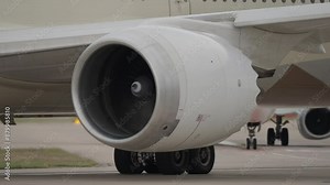 Close up of jet engine starting up on modern aircraft before take-off