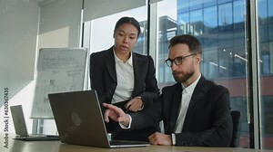 Yong businessmanyoung man and woman are working in the office. Colleagues discuss the project, possible options, financial calculations and the idea for a startup. Discuss online trading market