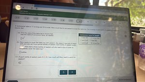 A rectangular table is 72 in long and 36 in wide. Mary would li... | Filo