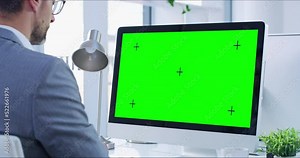 Greens creen, copyspace and chromakey on a computer screen with tracking markers and a business man working. Copy space for advertising, marketing and promotion with a corporate professional typing