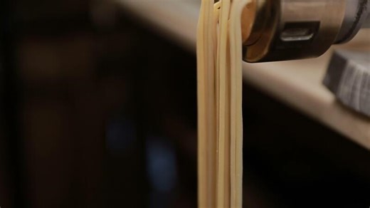 Making noodles with pasta machine from homemade spelt dough. Close up HD