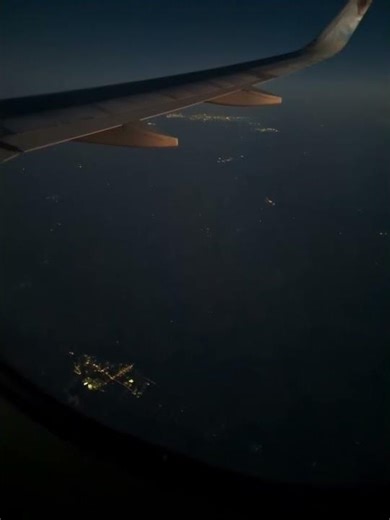 AIR PLANE WING VIEW AT NIGHT FROM AIR PLANE WINDOW