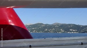 Corfu, Greece A high-speed passenger ferry passes water and islands under the blue sky