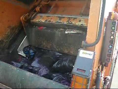 Garbage bags crushed by packer blade
