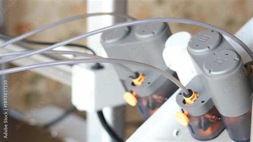 Close-up of 3D printer filament feeding system and mechanical components during operation. Concept of additive manufacturing hardware and modern production technology.