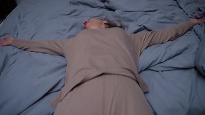 Free stock video - Woman laying on the bed at night