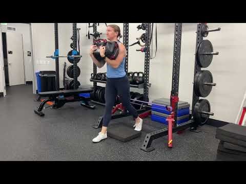 Stomp Split Squat with Sandbag Zercher Hold