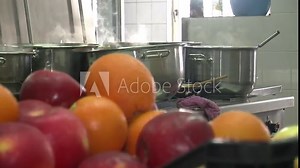 Steaming and boiling pot of water or delicious soup, on top of induction heating stove in clean and neat kitchen. Spices and herbs for cooking home made meals and recipes