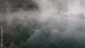 Morning haze over water surface in natural hot spring