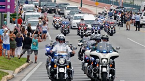 Outside Raynor funeral, residents salute Daytona Beach officer who 'did the right thing'