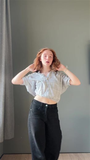 Dancing Moves by a Young Woman in Checkered Shirt